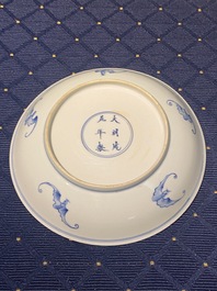 A Chinese verte biscuit figure, a green 'lotus' jar and a figurative blue and white plate, Kangxi and later